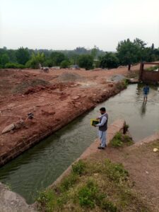 An officer from the Irrigation Department inspects the ongoing construction work.